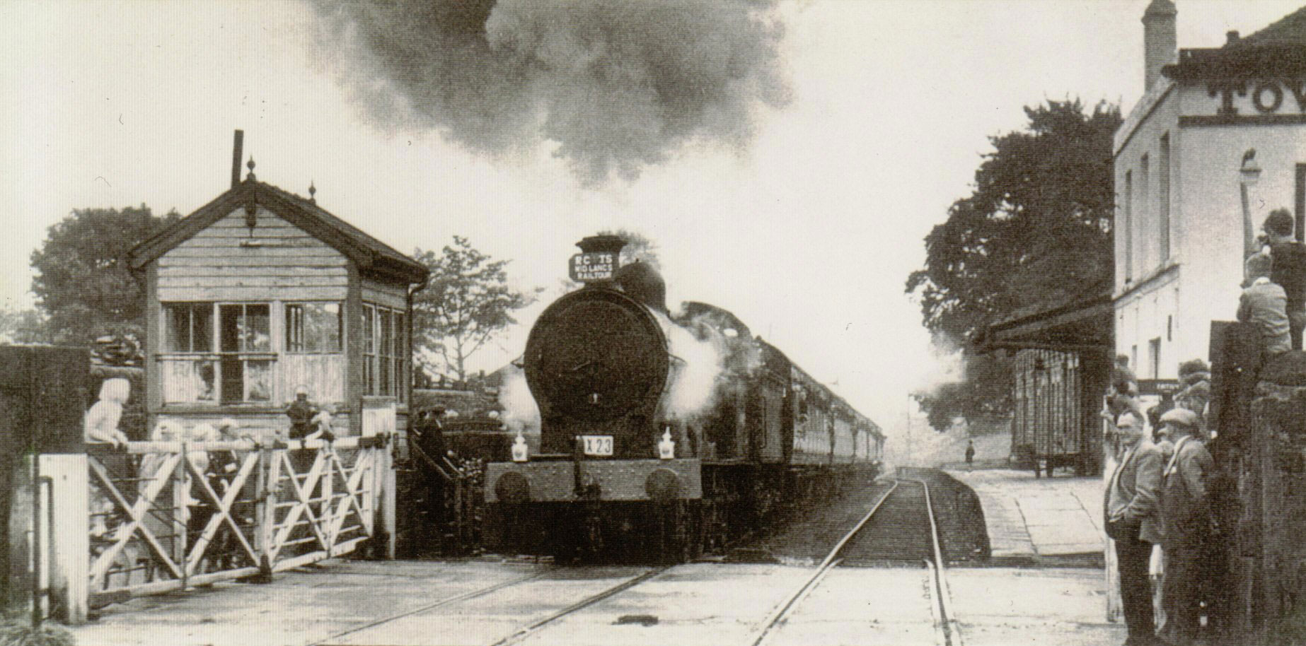 An old photograph of a steam train at the station